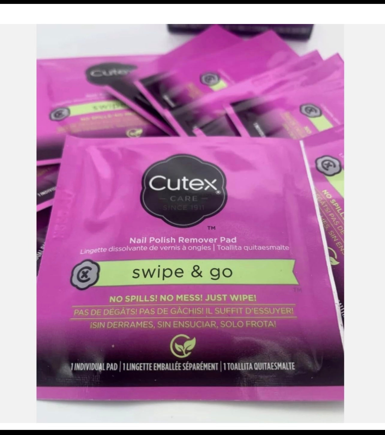 Cutex nail polish remover pads individual pads spread on a white background